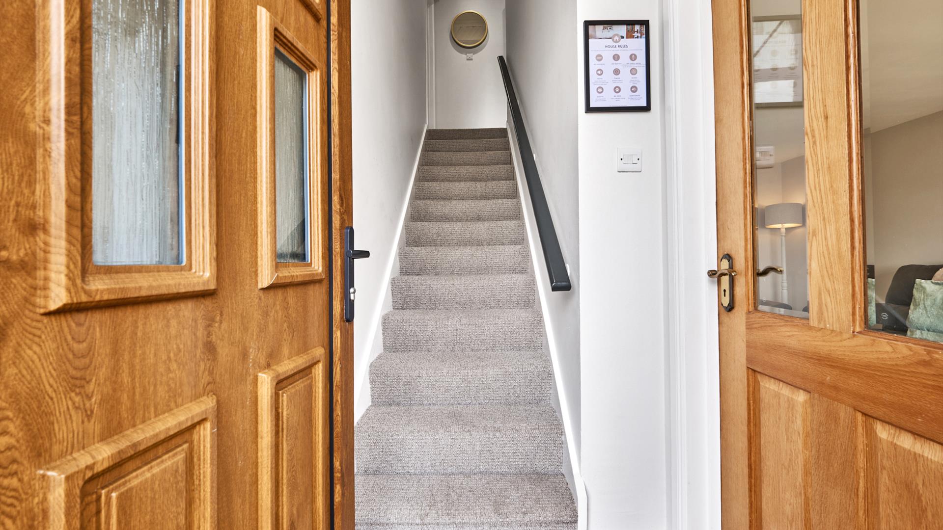 photograph of open front door leading into hall and stairs