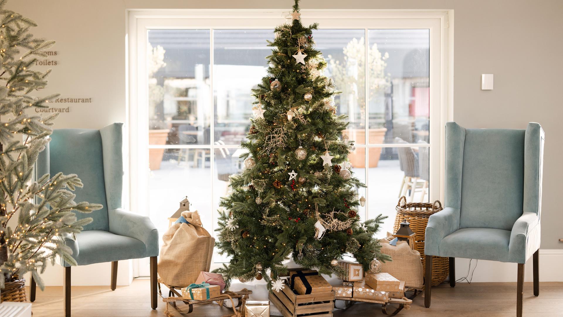 Christmas Tree in Hotel Lobby with presents laid at the base of the tree