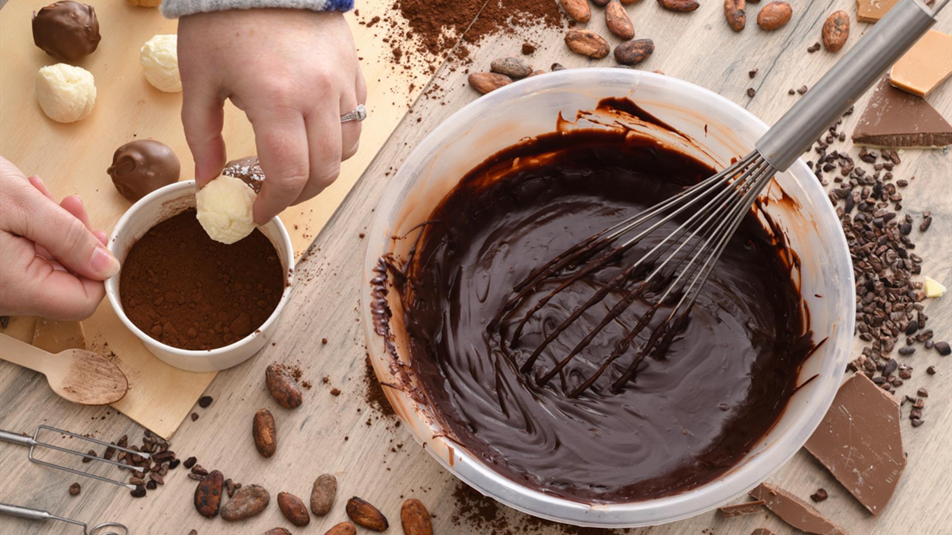 Coating truffles during the Truffle Shuffle experience at The Chocolate Manor