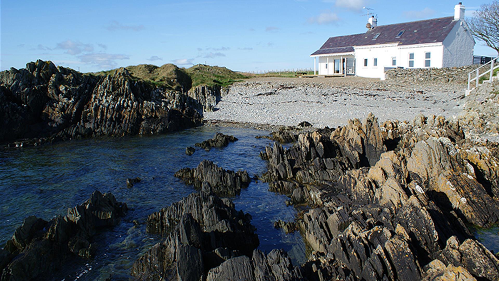 Back exterior with beach and rockshore