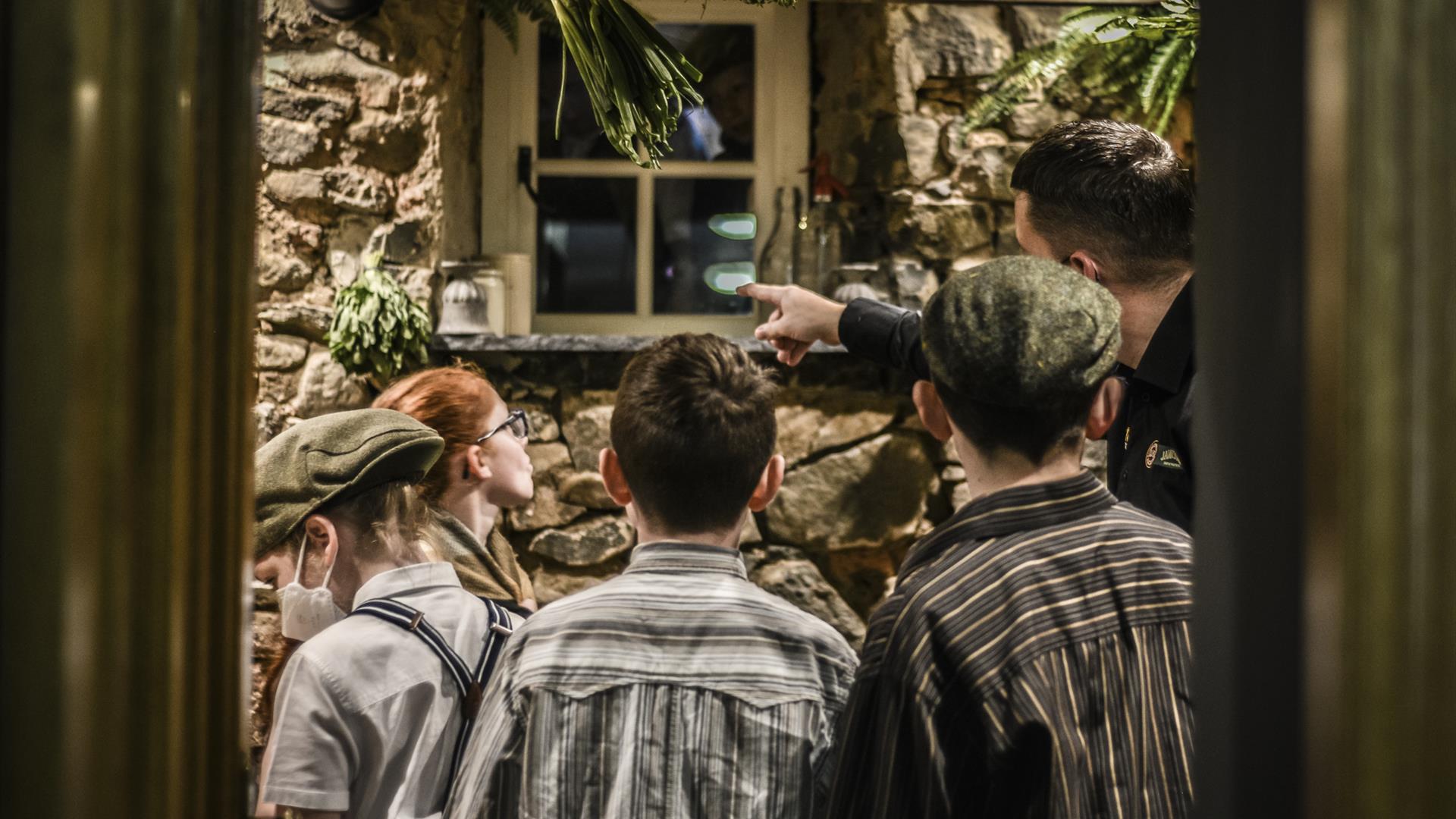 Image of kids being shown the soup kitchen window