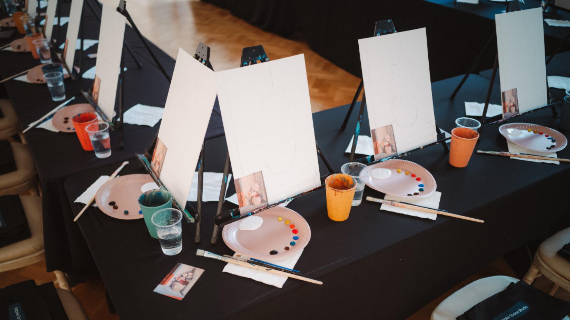 Photo of canvases, paint palettes and glasses of prosecco in the Ulster Museum