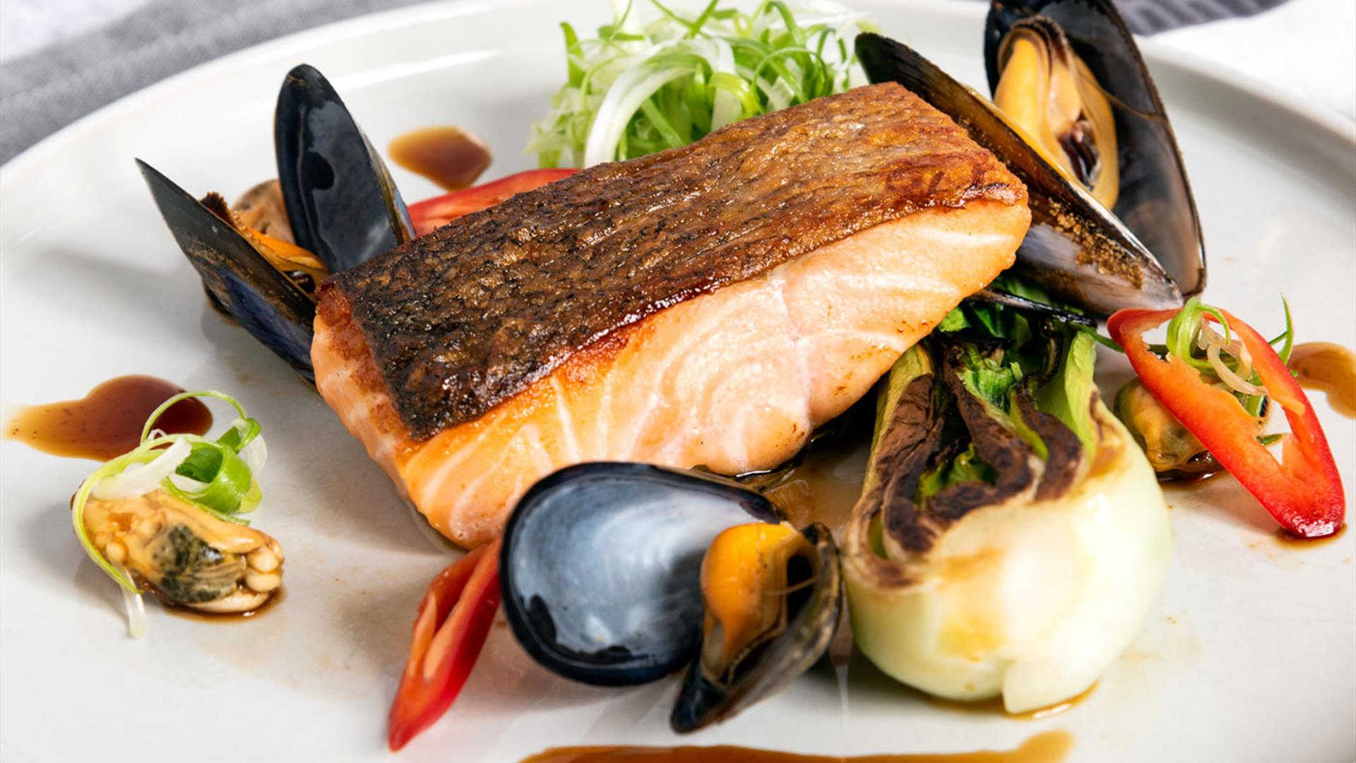 A plate of pan-seared Glenarm salmon, with Strangford Lough mussels and red chilli.