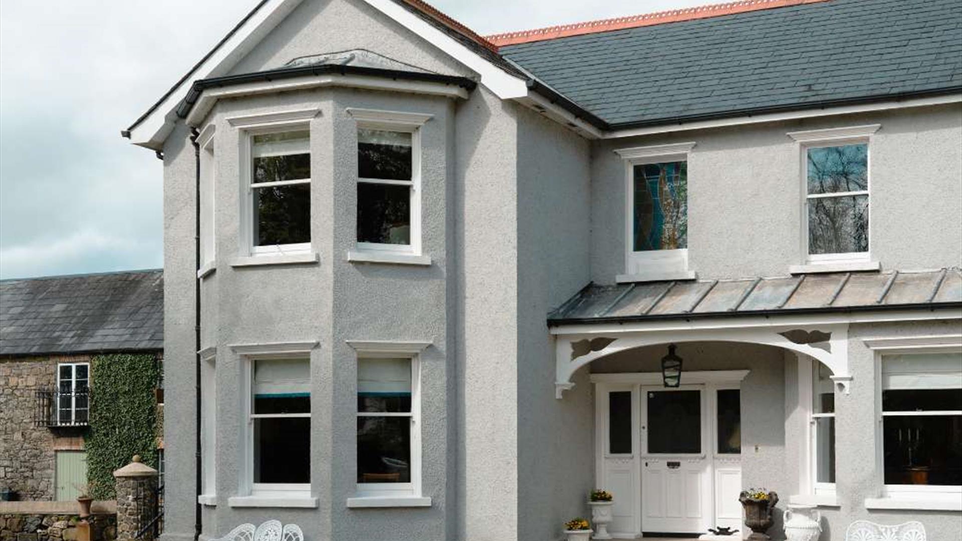 Front of large detached house with courtyard in background