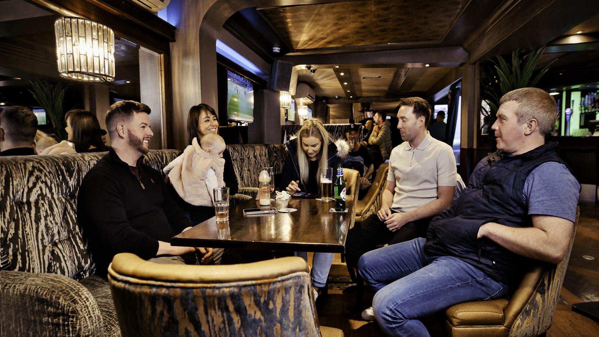 A group of friends sitting around table at Hagen's Bar