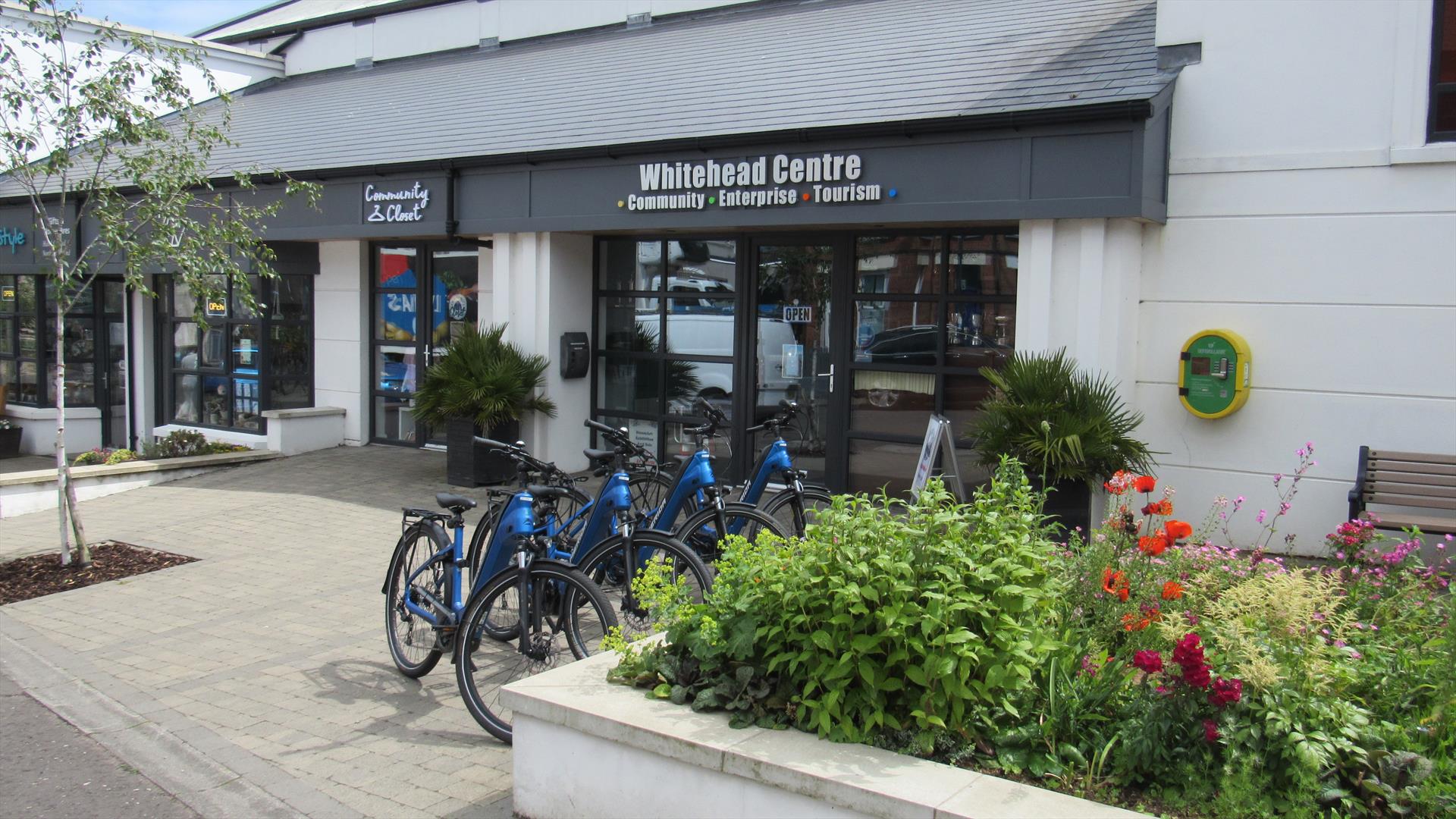 Photograph of Whitehead Centre with e-bikes display in a row.