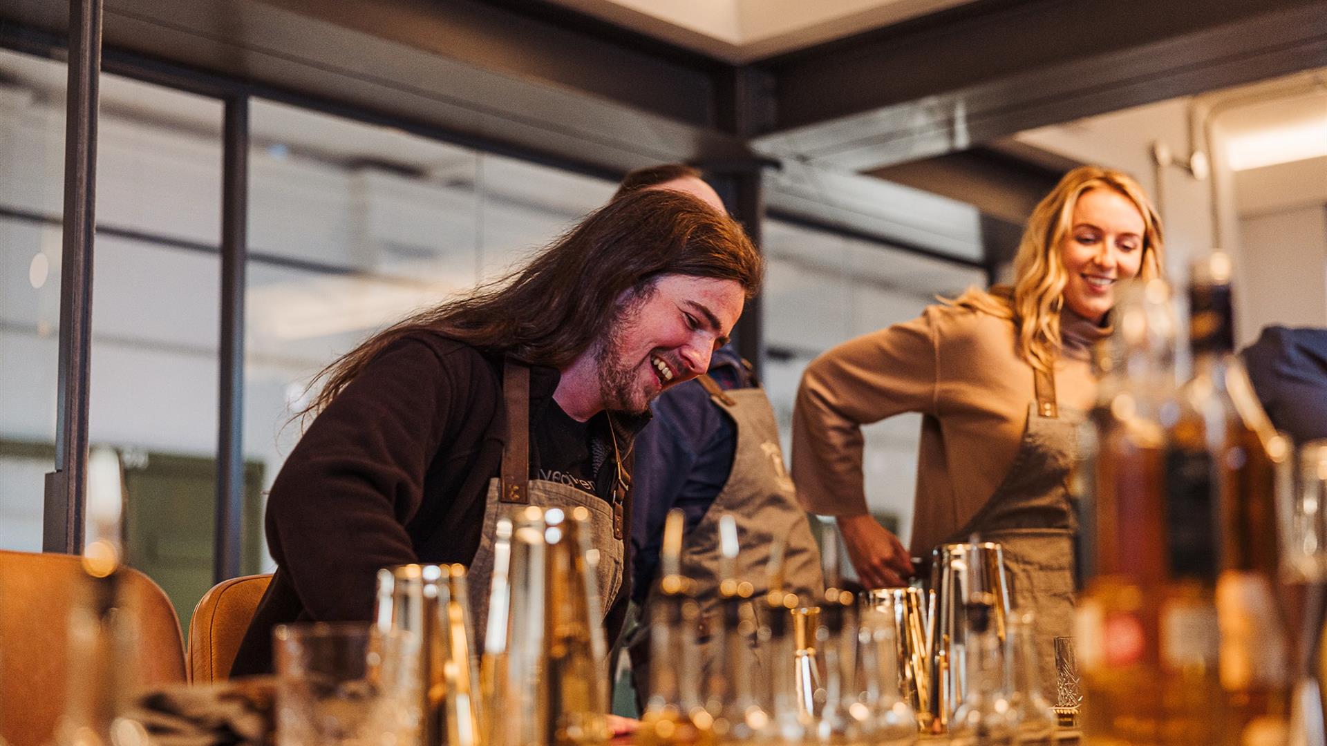 A couple preparing cocktails at McConnell's Distillery.