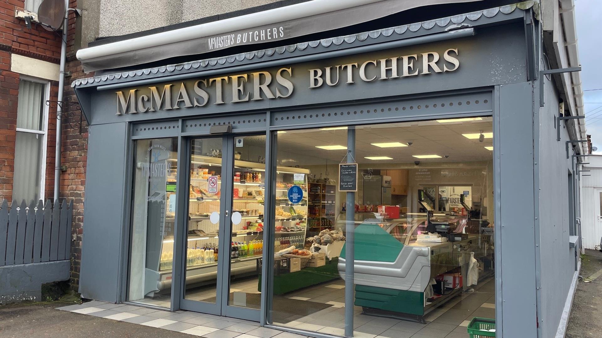 Grey shop frontage of McMasters Butchers in Whitehead