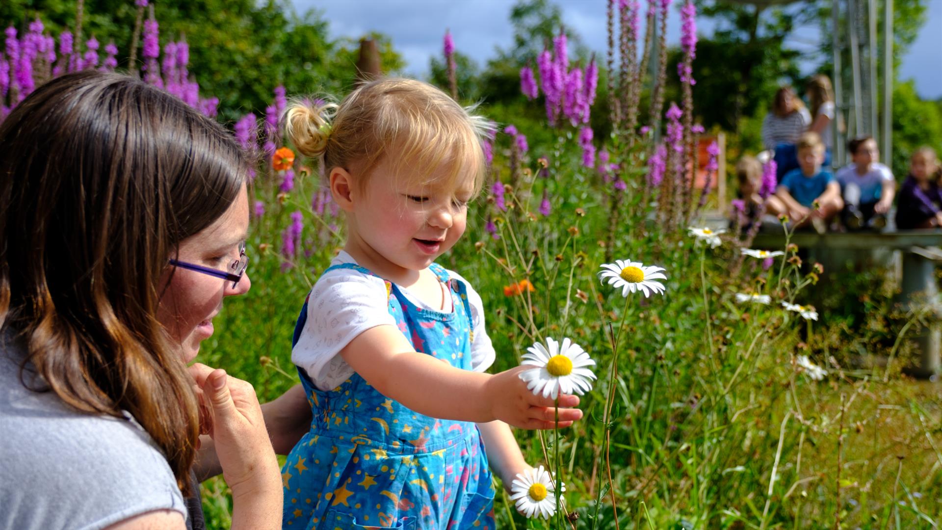 Mother and child looking at flowers.