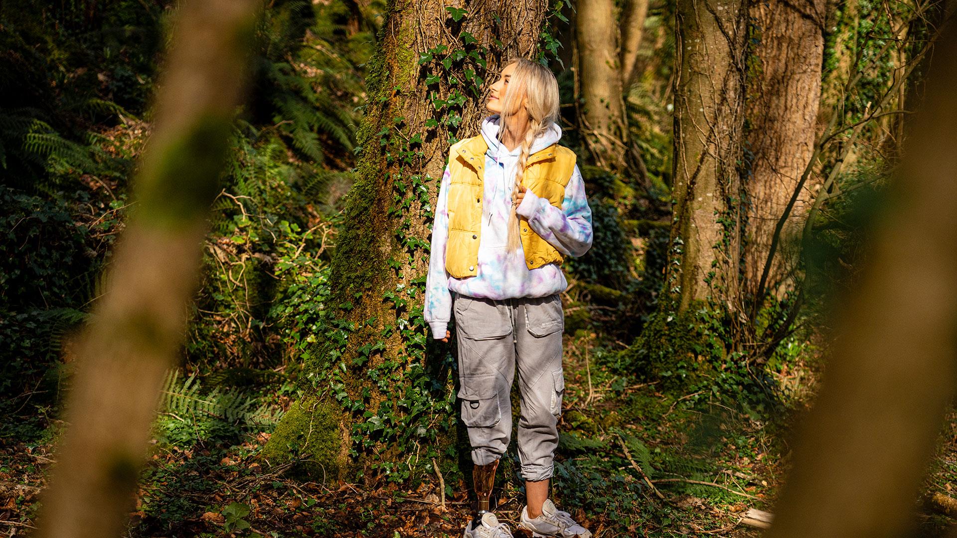 Girl standing pensively beside a tree as part of the Mussenden Unwind experience