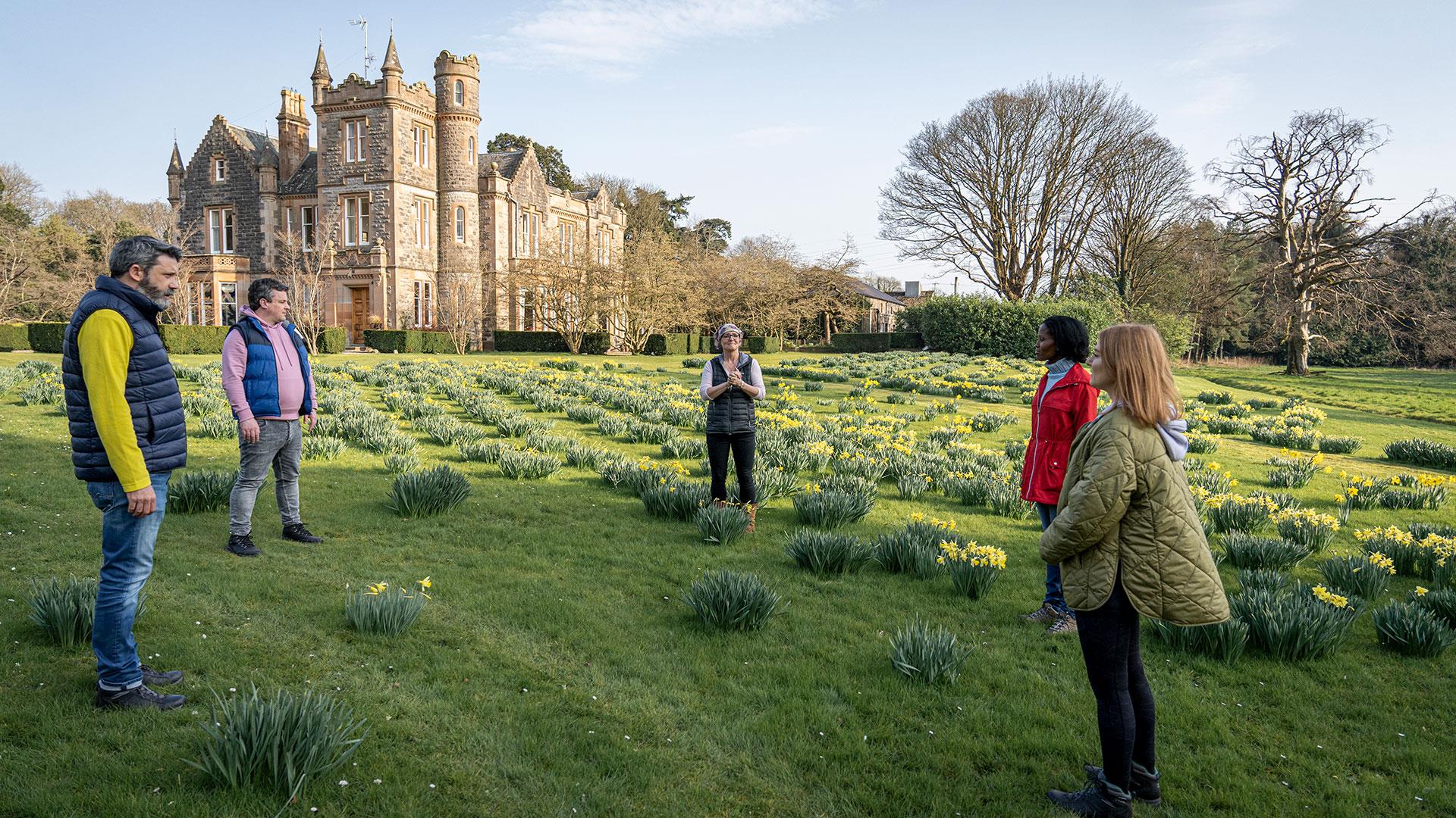 Group standing outside with Elmfield Estate in the background enjoying the Journey into Stillness experience