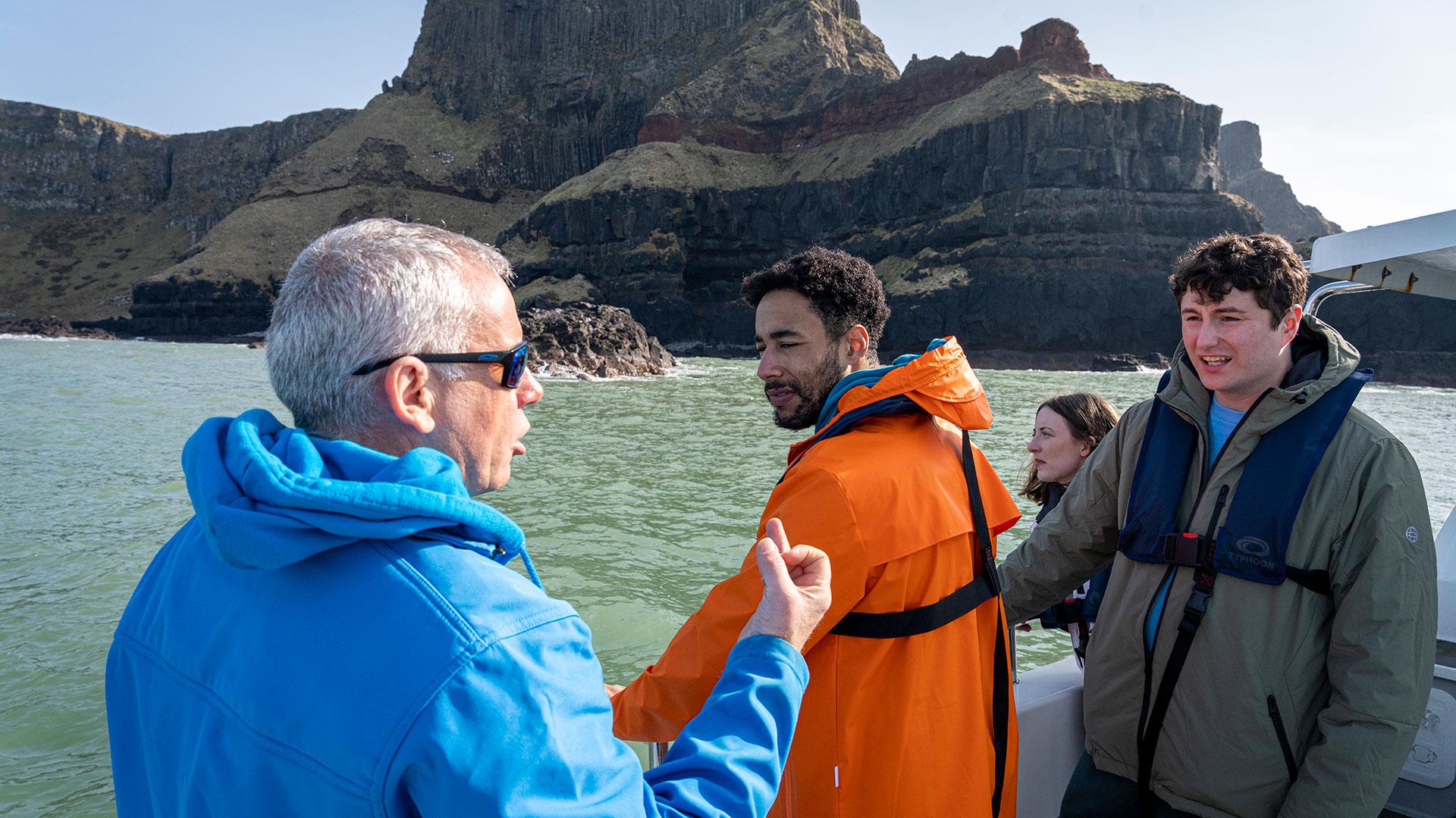 Guide/skipper of the boat talking to a group enjoying the Giant Shipwrecks of the North Coast experience