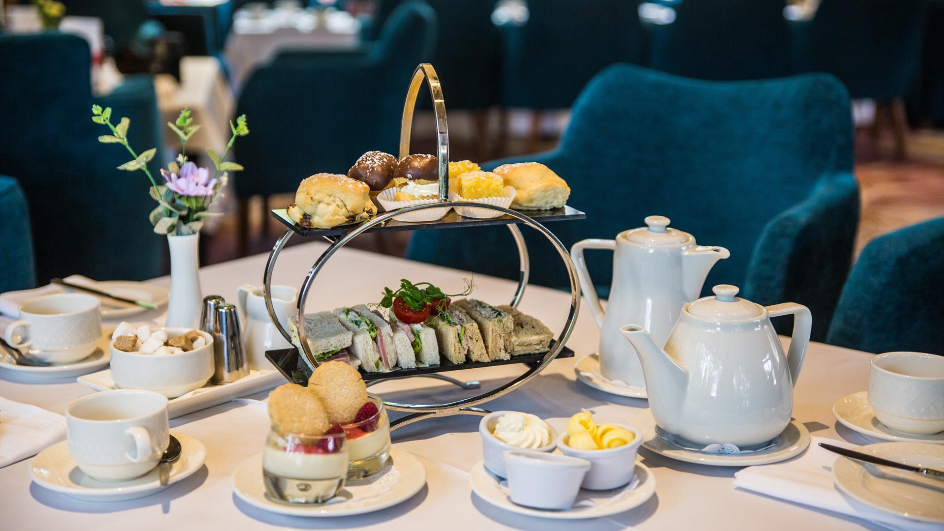 Afternoon tea in the Ross Park Hotel served on silver stand with white crockery and tablecloth