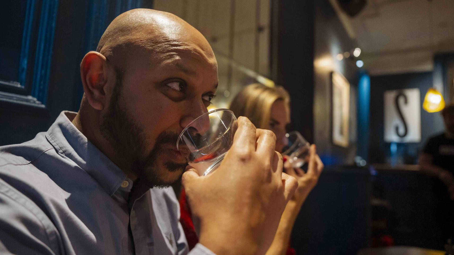 Guests taste mystery liquids during the Sensorium experience