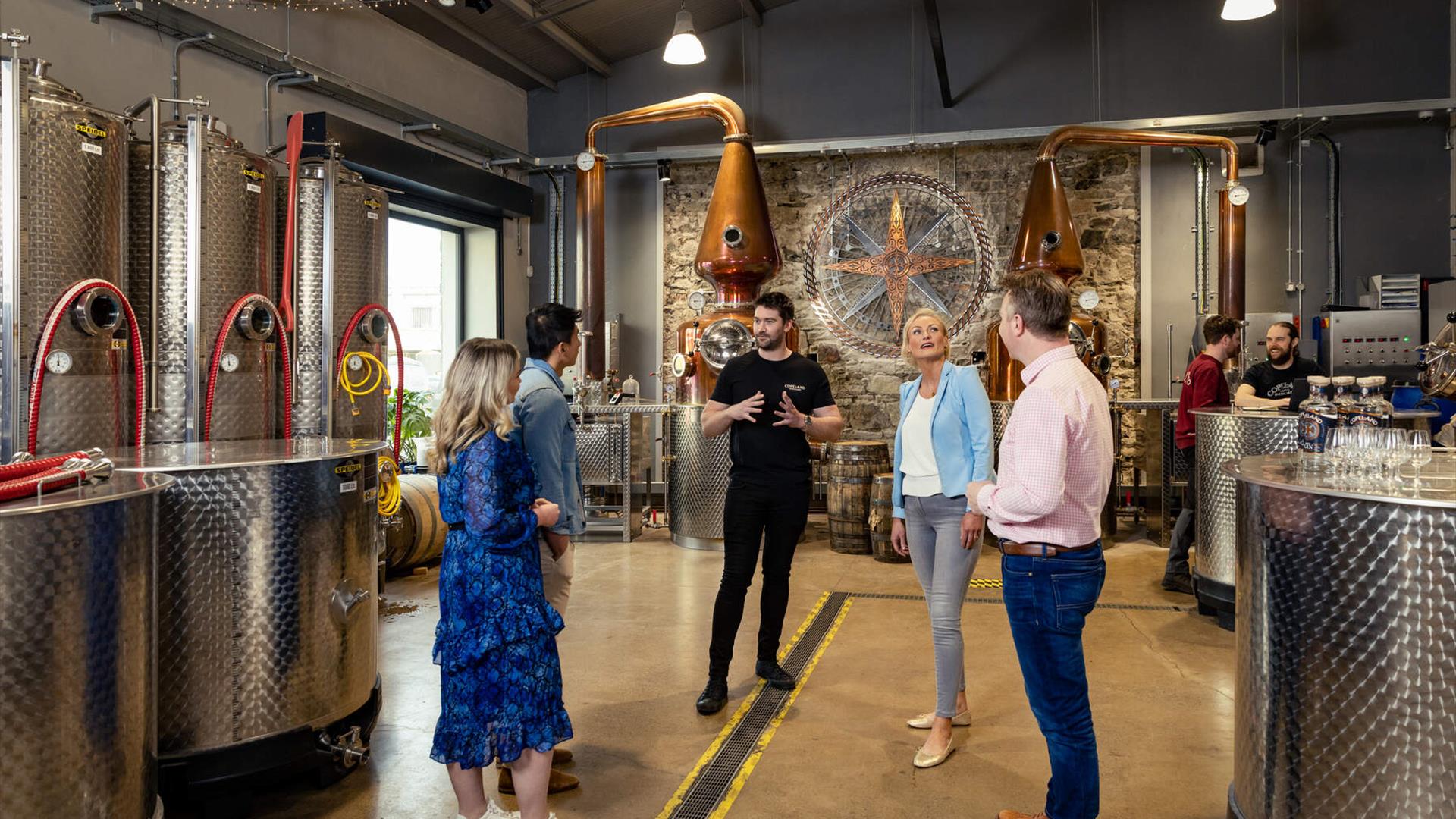 Tour group admire the stills within the Copeland Distillery