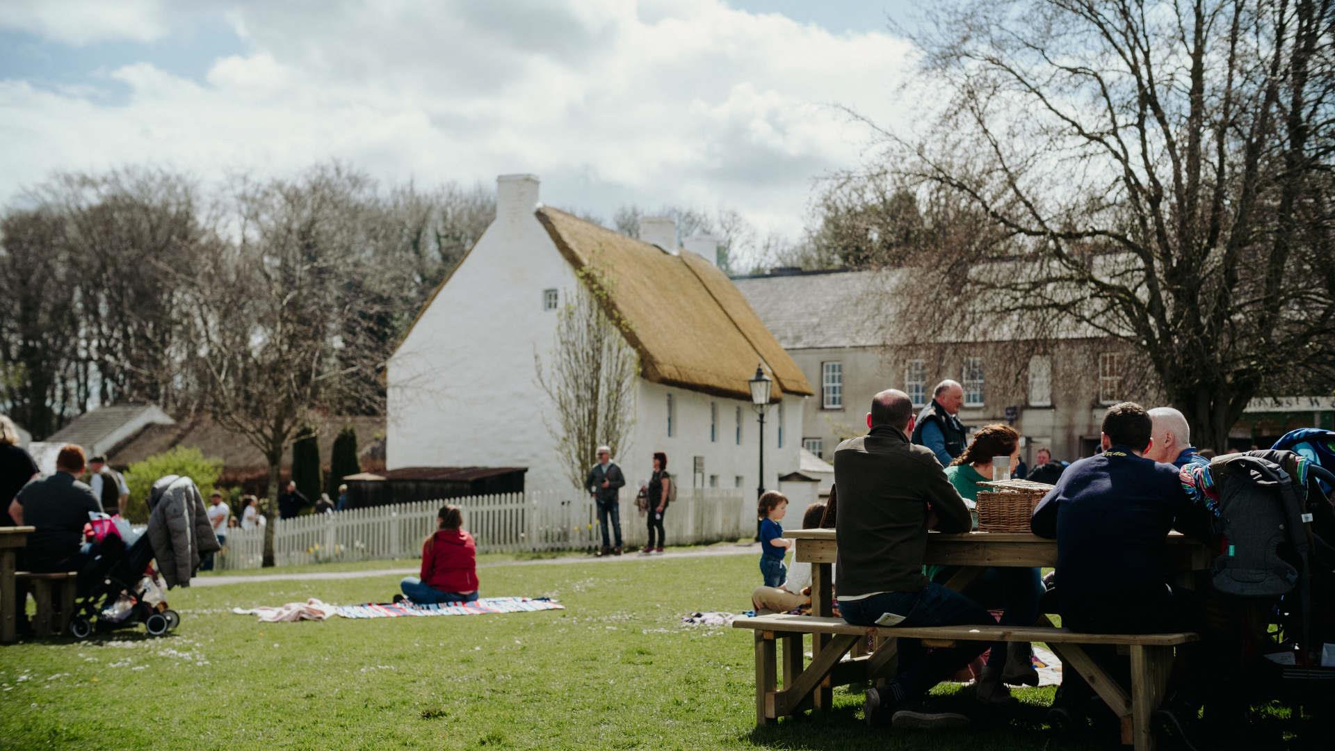 Visitors enjoying picnics in the grounds of the Folk Museum