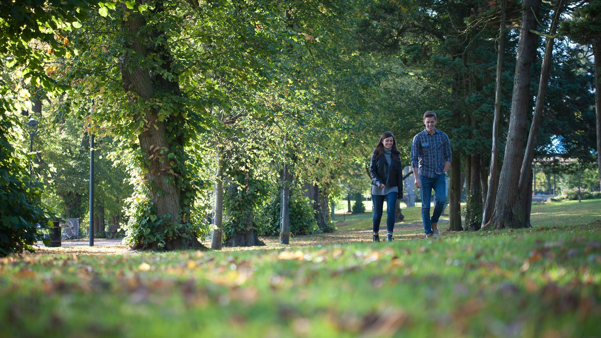 Image shows a woman and man walking in Wallace Park