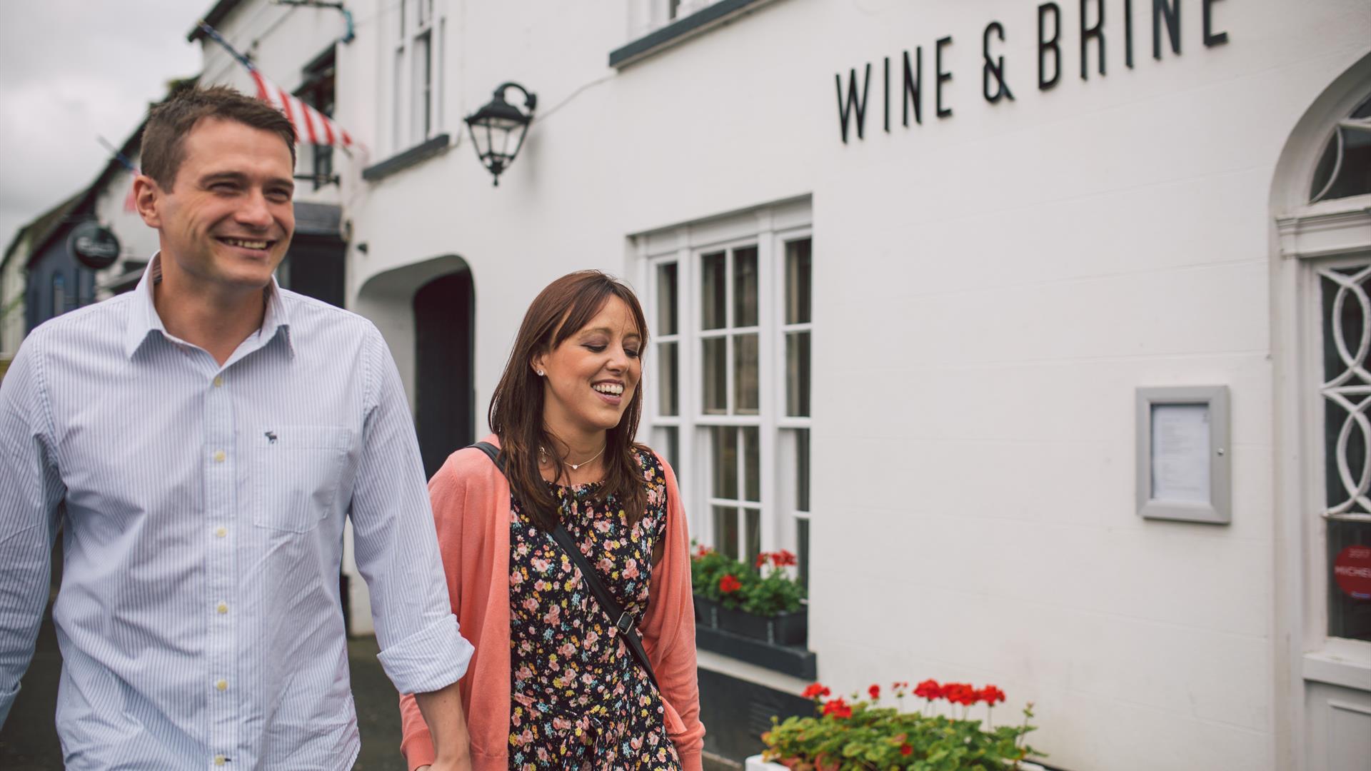 Couple walking outside the Wine & Brine restaurant