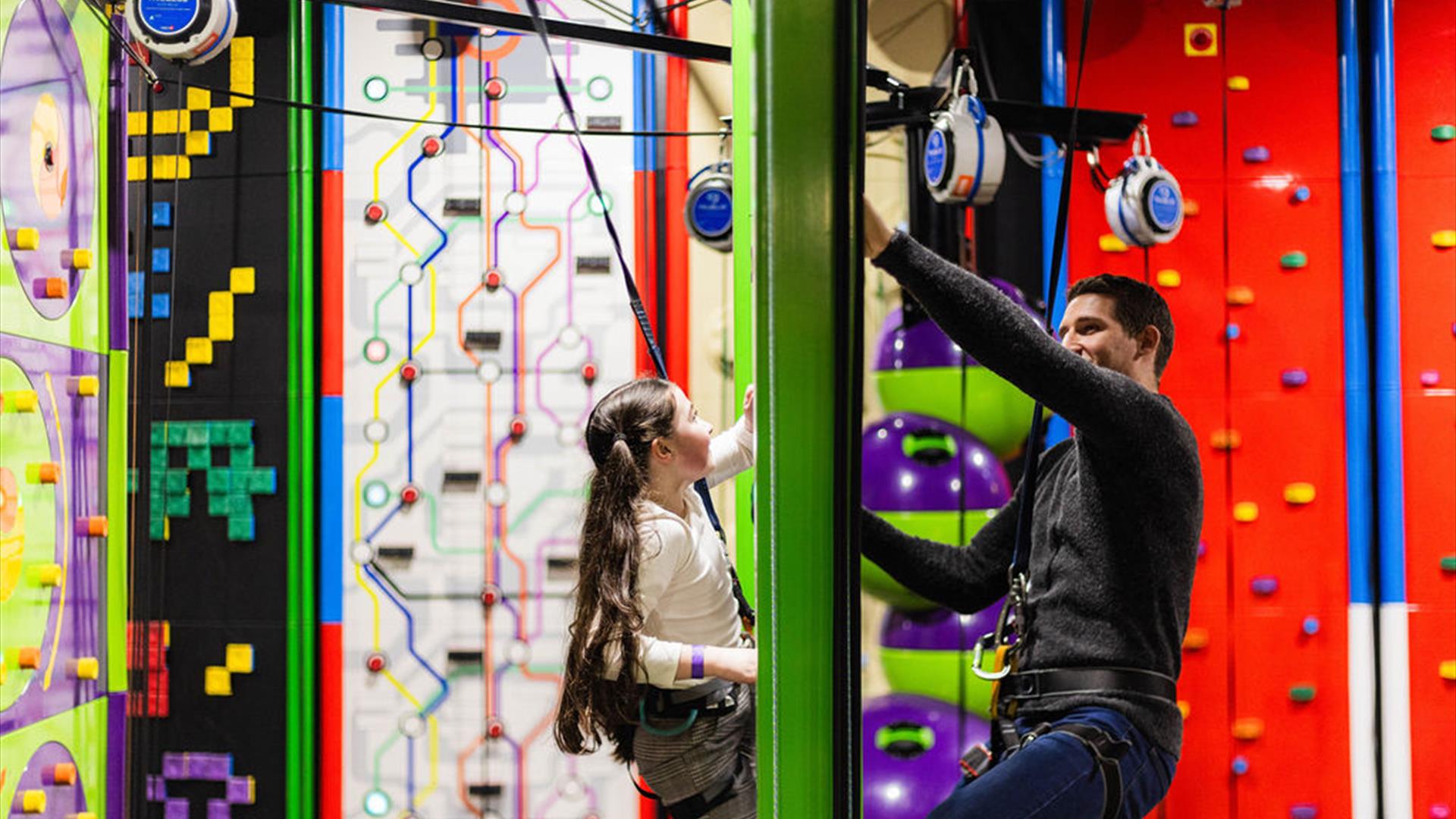 Young Girl and Dad on Face to Face Climbing Wall