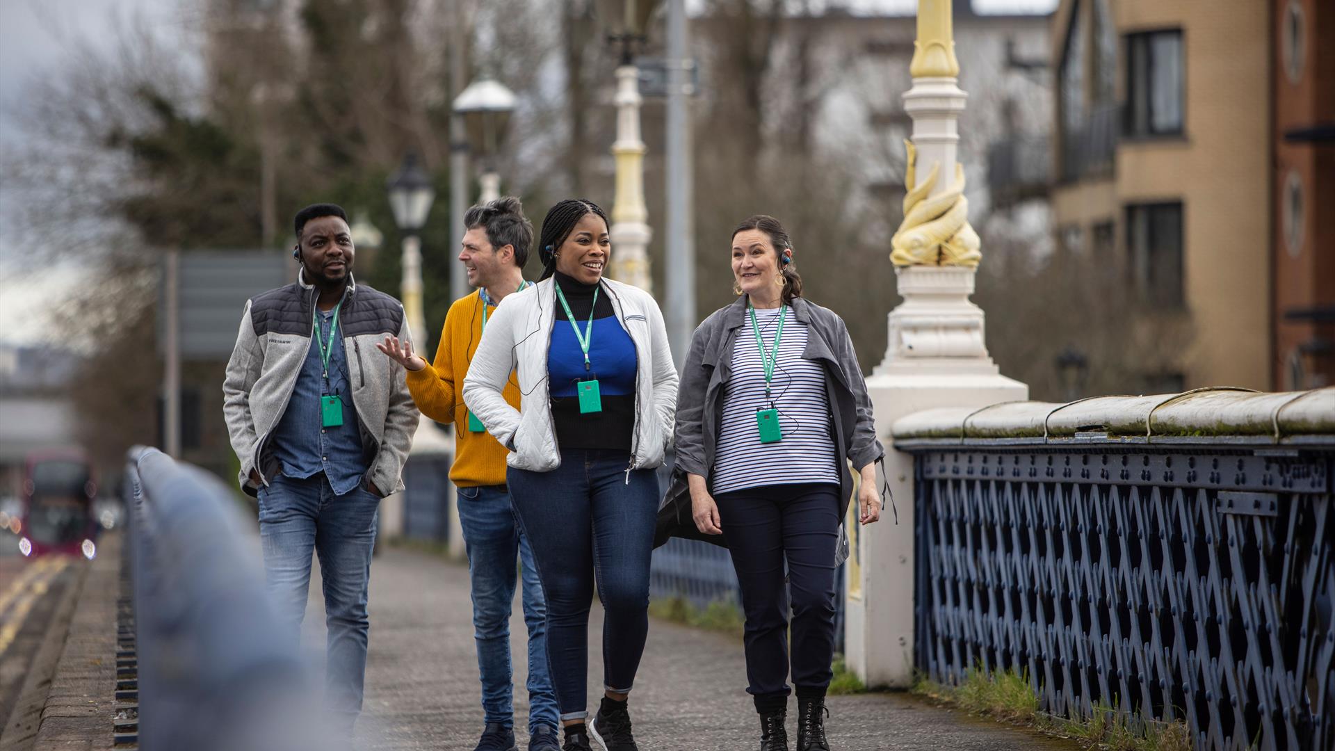 A tour group walking on the Queen's bridge in Belfast.