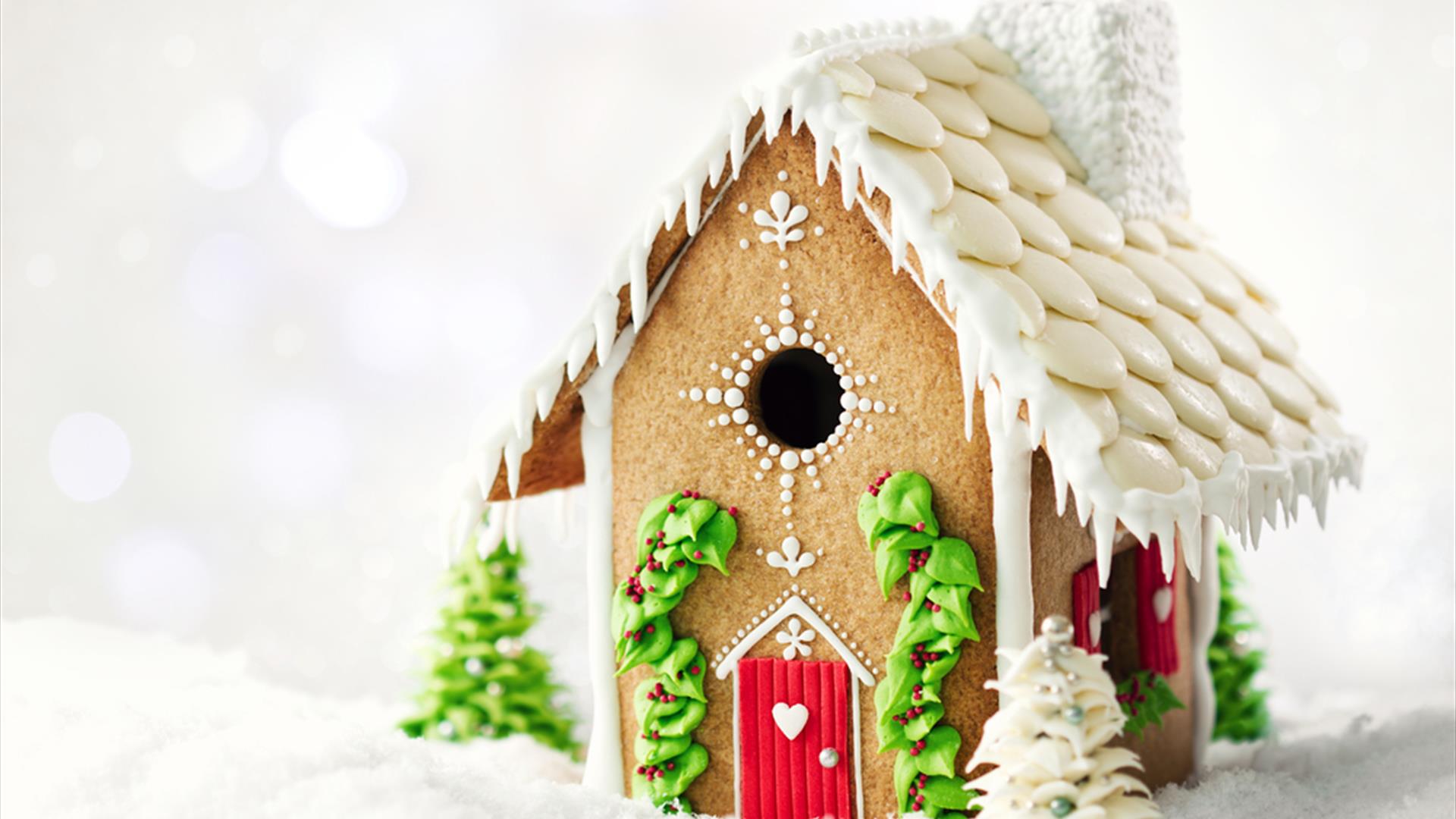 A gingerbread house decorated with white icing