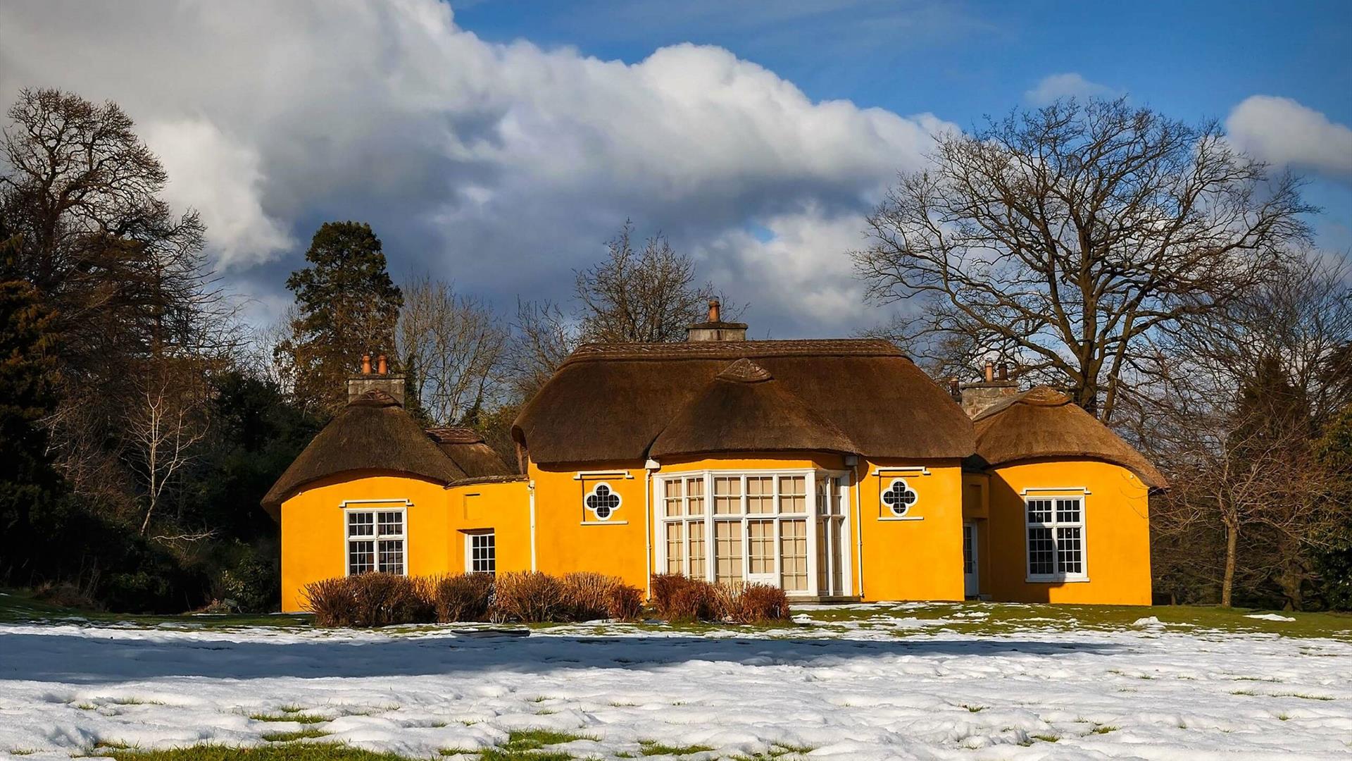 Image credit: Alan Hopps
Derrymore house. A bright yellow cottage with a thatched roof.