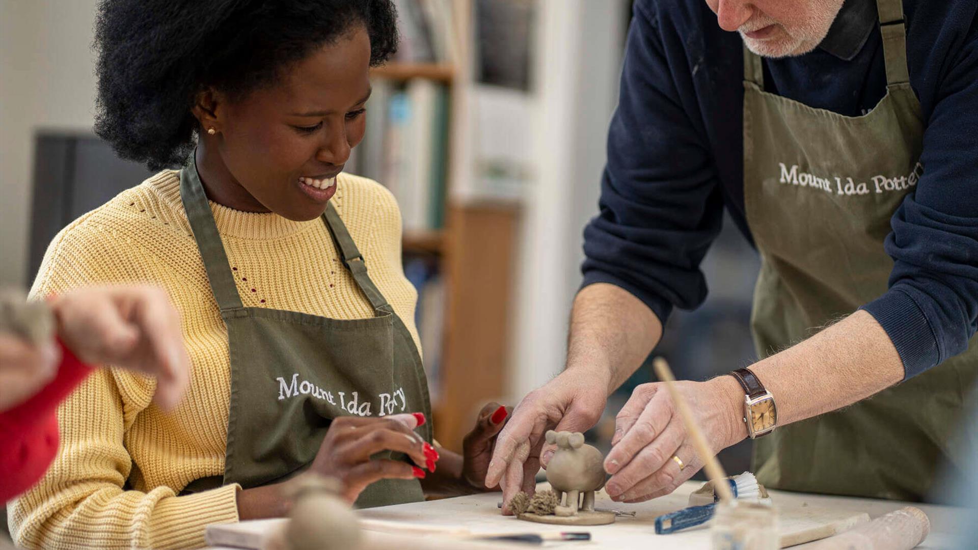 Potter Trevor Woods provides hands-on instruction during the Handmade to Last experience