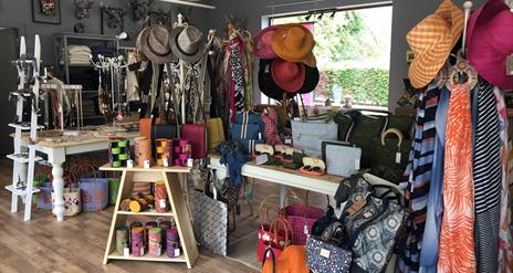 Shop with displays of hats, scarves, jewellery, handbags and more