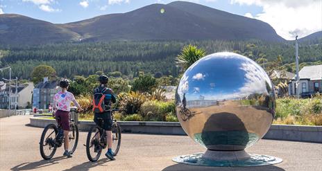 Cyclists on bikes from Bike Mourne, Newcastle admiring the Mourne Mountains from the Promenade, Newcastle, County Down