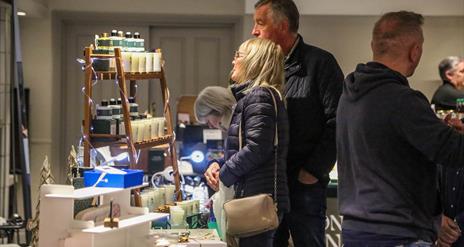 People browsing indoor market stalls