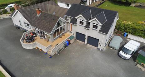 An arial view of a large country house with an annexe.