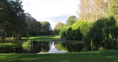 Image is of golf course with lake around it