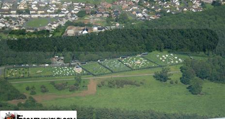 An arial view of a large activity centre next to a village.