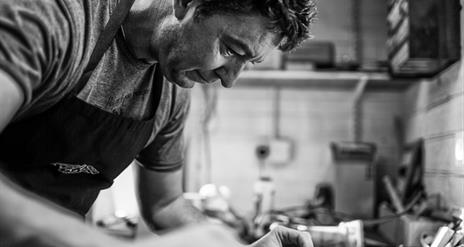 Photo showing a craftsman building a guitar from scratch