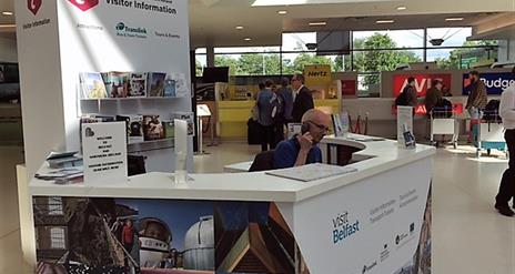 Receptionist on the phone at the visitor information kiosk.