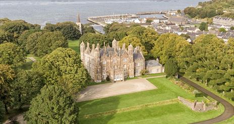 Aerial view of Glenarm Castle & Gardens with the ocean beyond.