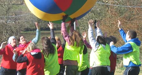 People playing a game with a large beach ball.