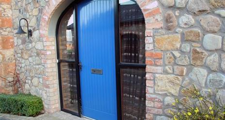 A bright blue door in an archway