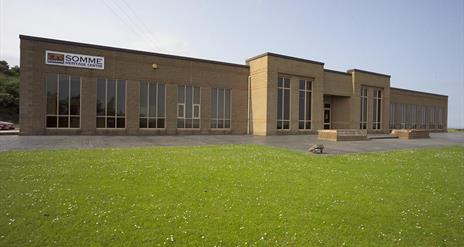 Photo of museum exterior and grassland to front