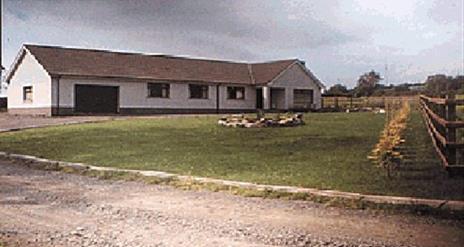 Driveway of a country Bungalow BnB with a large front lawn.