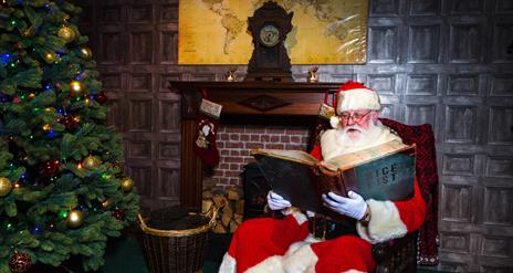 Father Christmas checking the Nice List