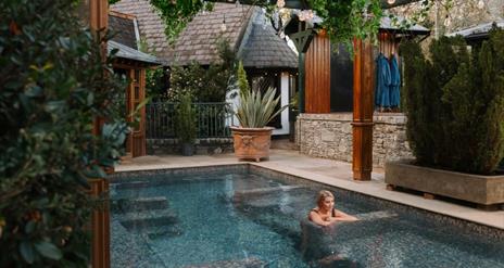 Blonde female in outdoor hot pool