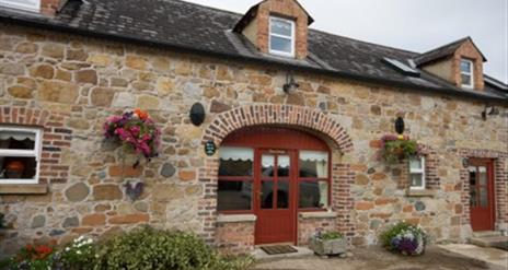 front door of cottage with stone walls