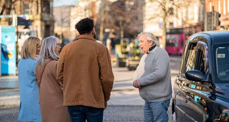 Billy Scott greets his tour group for the Belfast Black Cab Tour