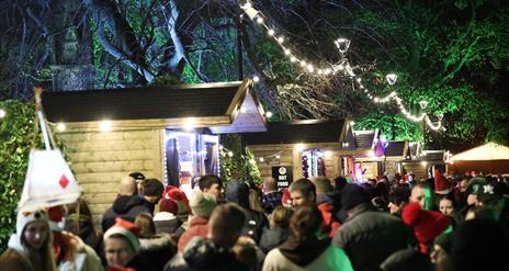 Image is of people enjoying the Christmas Market in Lisburn