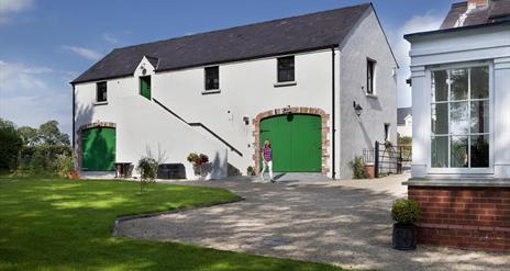 A lady walking outside the Barn at Lisnacurran