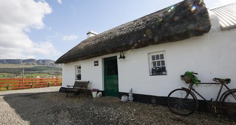 Traditional thatched cottage with mountain views