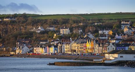 Whitehead promenade with coloured houses and old outdoor swimming pool