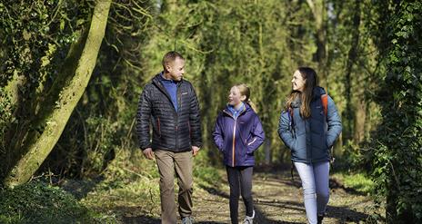 A family walk along a woodland path at Ballyronan Wood.