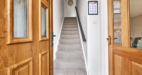 photograph of open front door leading into hall and stairs